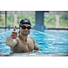 young healthy with muscular body man swim on swimming pool and representing healthy and recreation concept