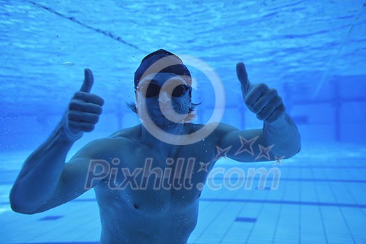 undervater shoot of swimming pool with good looking young swimmer 