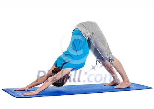 Yoga - young beautiful woman yoga instructor doing Downward Facing Dog (adho mukha svanasana) asana exercise isolated on white background Yoga - young beautiful woman yoga instructor doing Downward Facing Dog (adho mukha svanasana) asana exercise isolated on white background