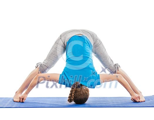 Yoga - young beautiful slender woman yoga instructor doing Wide Legged standing Forward Bend D (Prasarita Padottanasana D) asana exercise isolated on white background Yoga - young beautiful slender woman yoga instructor doing Wide Legged standing Forward Bend D (Prasarita Padottanasana D) asana exercise isolated on white background