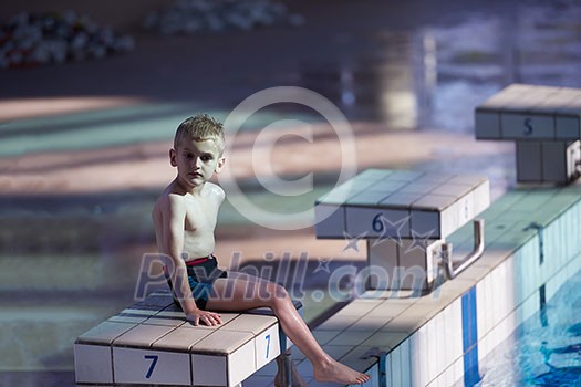 happy little child portrait on swimming school classes and recreation at indoor pool