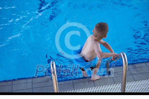 happy little child portrait on swimming school classes and recreation at indoor pool happy little child portrait on swimming school classes and recreation at indoor pool