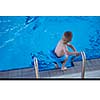 happy little child portrait on swimming school classes and recreation at indoor pool