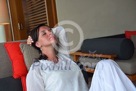 happy young woman relax at home on sofa in bright living room and watching tv happy young woman relax at home on sofa in bright living room and watching tv