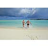 happy young  couple at summer vacation have fun and relax at beautiful sunny  day on beach