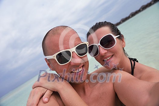 happy young couple at summer vacation have fun and relax at beautiful sunny day on beach happy young couple at summer vacation have fun and relax at beautiful sunny day on beach