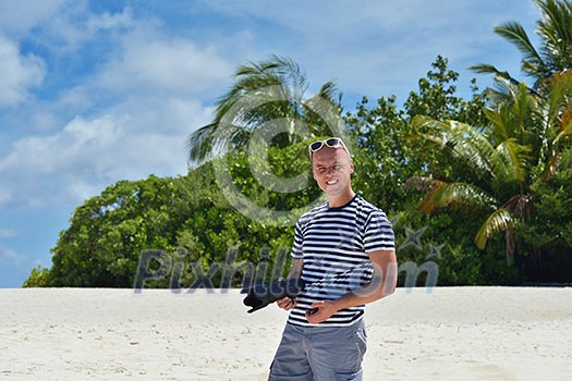 photographer taking photo of models couple on beautiful tropical beach at summer photographer taking photo of models couple on beautiful tropical beach at summer