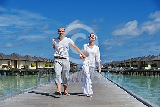 happy young couple have fun and relax at summer vacation on background maldives travel location and beautiful white sand beach happy young couple have fun and relax at summer vacation on background maldives travel location and beautiful white sand beach