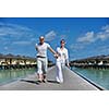happy young couple have fun and relax at summer vacation on background maldives travel location and beautiful white sand beach