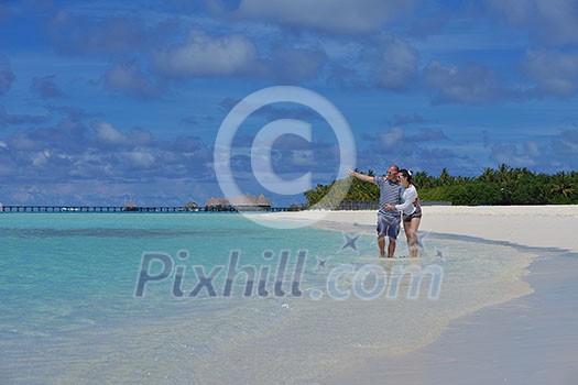 happy young couple have fun and relax at summer vacation on background maldives travel location and beautiful white sand beach happy young couple have fun and relax at summer vacation on background maldives travel location and beautiful white sand beach