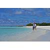 happy young couple have fun and relax at summer vacation on background maldives travel location and beautiful white sand beach