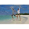 happy young romantic couple in love have fun running and relaxing on beautiful beach