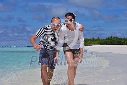 happy young couple at summer vacation have fun and relax at beautiful sunny day on beach happy young couple at summer vacation have fun and relax at beautiful sunny day on beach