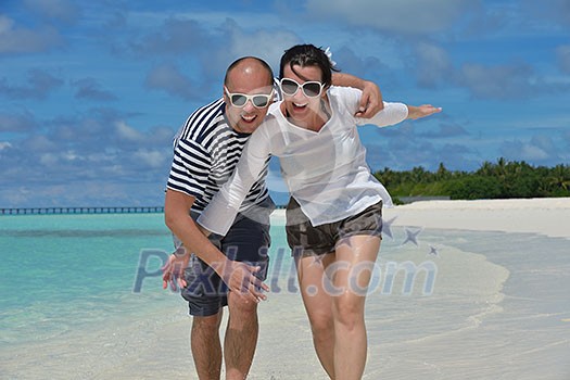 happy young couple have fun and relax at summer vacation on background maldives travel location and beautiful white sand beach happy young couple have fun and relax at summer vacation on background maldives travel location and beautiful white sand beach