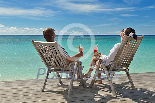 happy young couple relax and take fresh drink at summer vacation happy young couple relax and take fresh drink at summer vacation