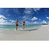 happy young couple have fun and relax at summer vacation on background maldives travel location and beautiful white sand beach