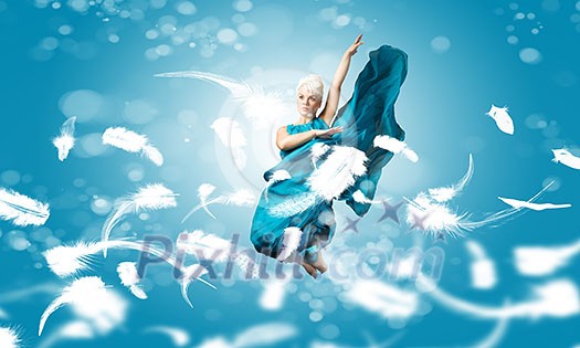 Young attractive woman in blue dress jumping high Young attractive woman in blue dress jumping high
