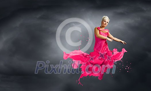 Young attractive woman in pink dress jumping high Young attractive woman in pink dress jumping high
