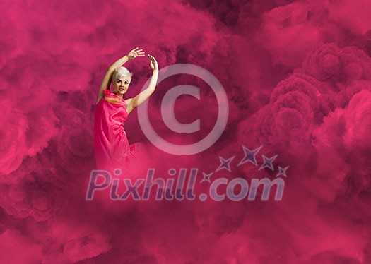 Young attractive woman in pink dress jumping high Young attractive woman in pink dress jumping high