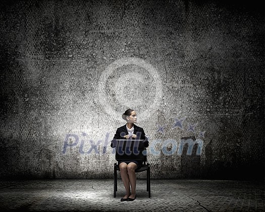 Young thoughtful confused businesswoman sitting on chair Young thoughtful confused businesswoman sitting on chair