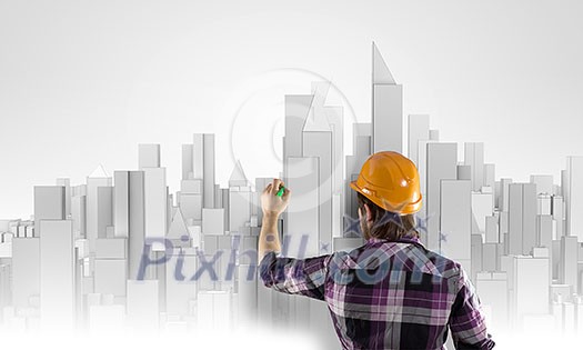 Rear view of engineer drawing project of business district Rear view of engineer drawing project of business district
