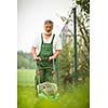 Senior man gardening in his garden (color toned image)
