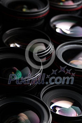 Modern camera lenses with reflections, low key image Modern camera lenses with reflections, low key image