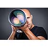 Young, pro male photographer in his studio during a photo shoot (color toned image; shallow DOF)