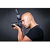 Young, pro male photographer in his studio during a photo shoot (color toned image; shallow DOF)