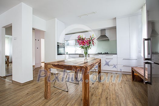 Modern Kitchen Interior Design Architecture Stock Image, Photo of a modern white kitchen with a dark wood table, hi-end appliances and plenty of daylight Modern Kitchen Interior Design Architecture Stock Image, Photo of a modern white kitchen with a dark wood table, hi-end appliances and plenty of daylight