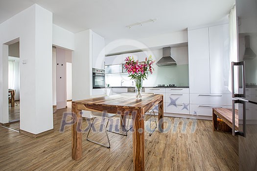 Modern Kitchen Interior Design Architecture Stock Image, Photo of a modern white kitchen with a dark wood table, hi-end appliances and plenty of daylight