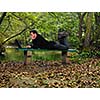 one young businessman working on laptop outdoor with green nature in backgroundone young businessman working on laptop outdoor with green nature in background