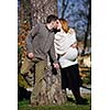 happy young married family couple outdoor in nature have fun and waiting baby and representing young family growth and pregnancy concept