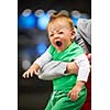 young mother with baby in shopping mall supermarket store buying food and grocery