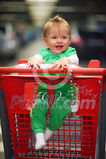 happy smilling baby child in grocery supermarket store shopping cart happy smilling baby child in grocery supermarket store shopping cart
