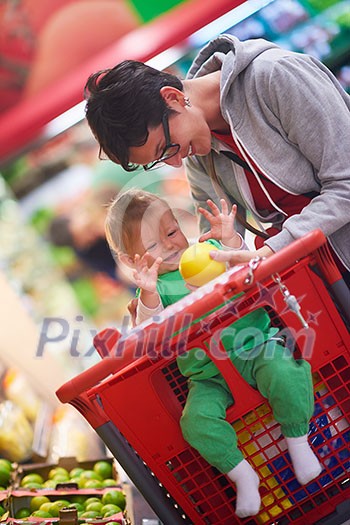 young mother with baby in shopping mall supermarket store buying food and grocery young mother with baby in shopping mall supermarket store buying food and grocery