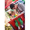 young mother with baby in shopping mall supermarket store buying food and grocery