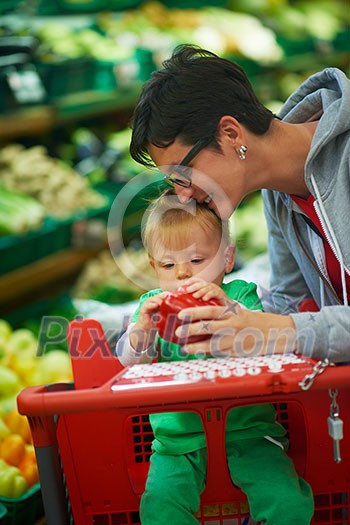 young mother with baby in shopping mall supermarket store buying food and grocery young mother with baby in shopping mall supermarket store buying food and grocery