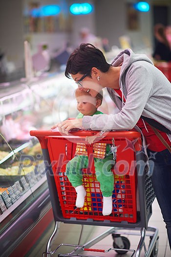 young mother with baby in shopping mall supermarket store buying food and grocery young mother with baby in shopping mall supermarket store buying food and grocery