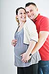 young family couple together in studio isolated on white. happy and waiting for baby