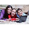 happy young family with mom and kids have fun and play in modern new living room home indoor