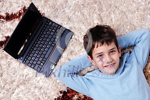 happy child boy relax at home with laptop computer in background happy child boy relax at home with laptop computer in background