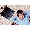 happy child boy relax at home with laptop computer in background