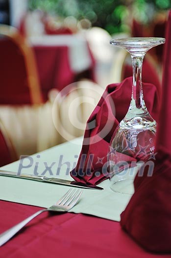 restaurant table with empty wine glass and red table decoration restaurant table with empty wine glass and red table decoration