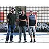 group of three adult man outdoor in the city at the sunset representing urban and modern everyday scene