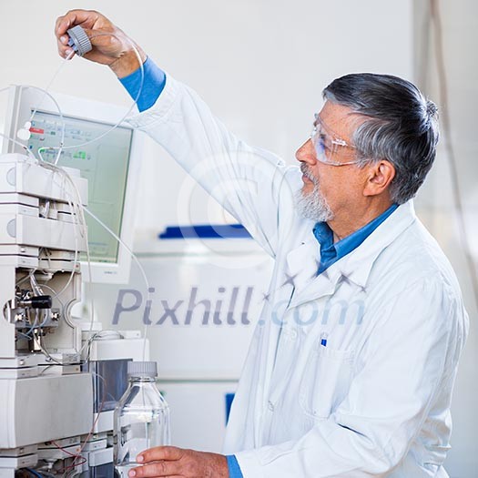 Senior male researcher carrying out scientific research in a lab (shallow DOF; color toned image) Senior male researcher carrying out scientific research in a lab (shallow DOF; color toned image)