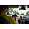 Man driving a car with his hands on the steering wheel