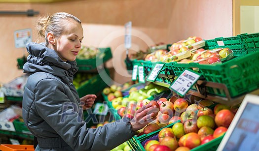 Beautiful, young woman shopping for fruits and vegetables in produce department of a grocery store/supermarket (shallow DOF; color toned image) Beautiful, young woman shopping for fruits and vegetables in produce department of a grocery store/supermarket (shallow DOF; color toned image)