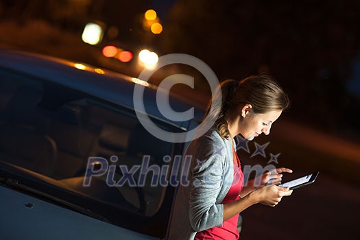 Pretty, female driver using her tablet computer (shallow DOF; color toned image) Pretty, female driver using her tablet computer (shallow DOF; color toned image)