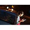 Pretty, female driver using her tablet computer (shallow DOF; color toned image)